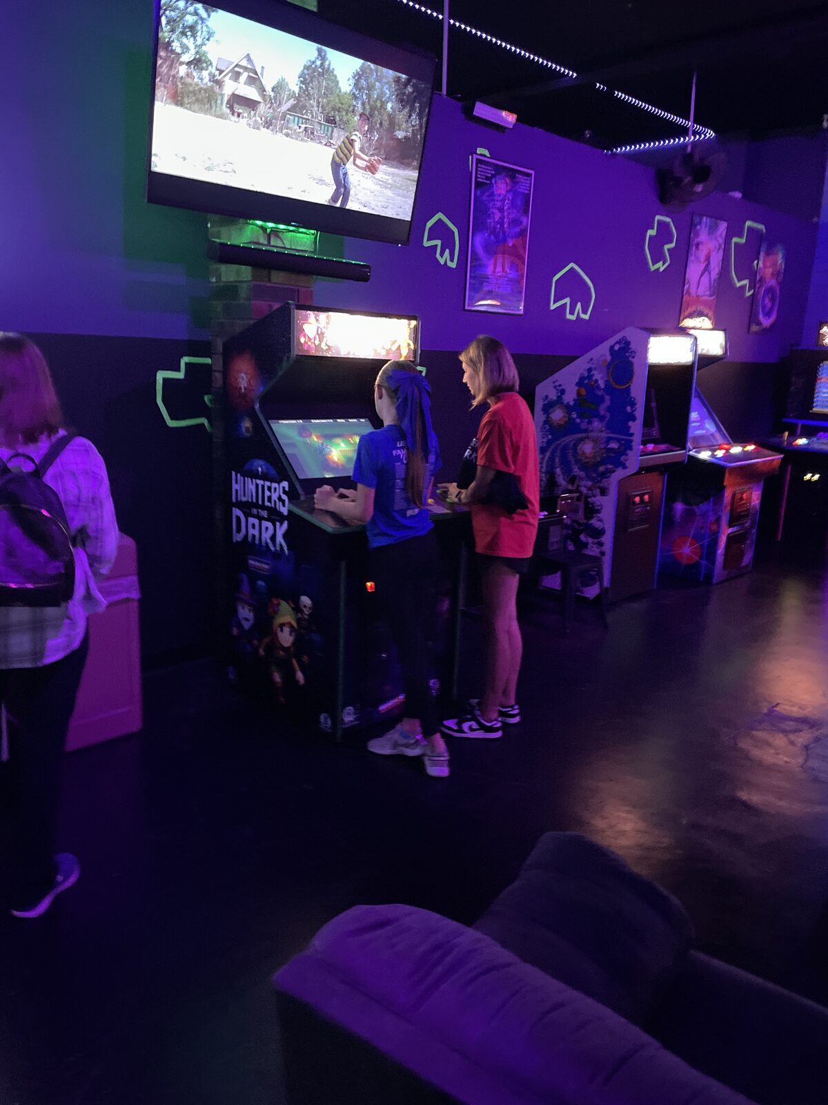 Two players at the Hunters In The Dark arcade cabinet at Waybacks Arcade